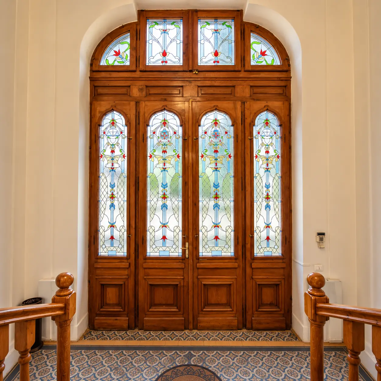 The stained-glass entrance door seen from inside the hall