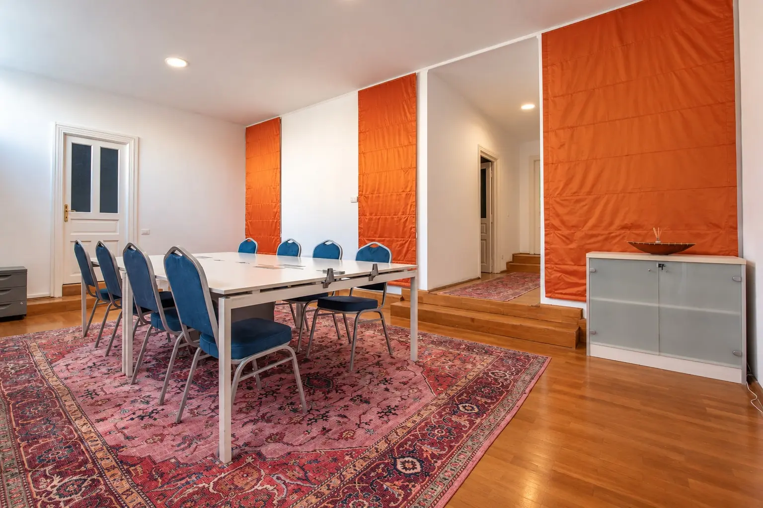 Modern Conference Room with Orange Accents (view 1)