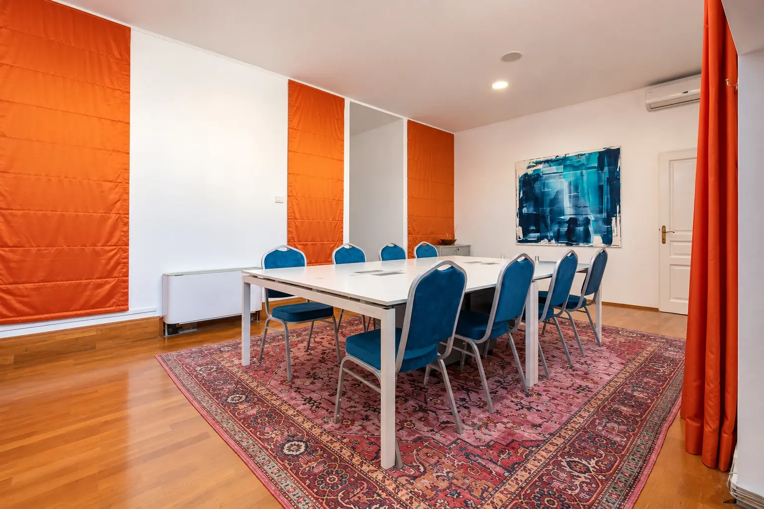 Modern Conference Room with Orange Accents (view 2)