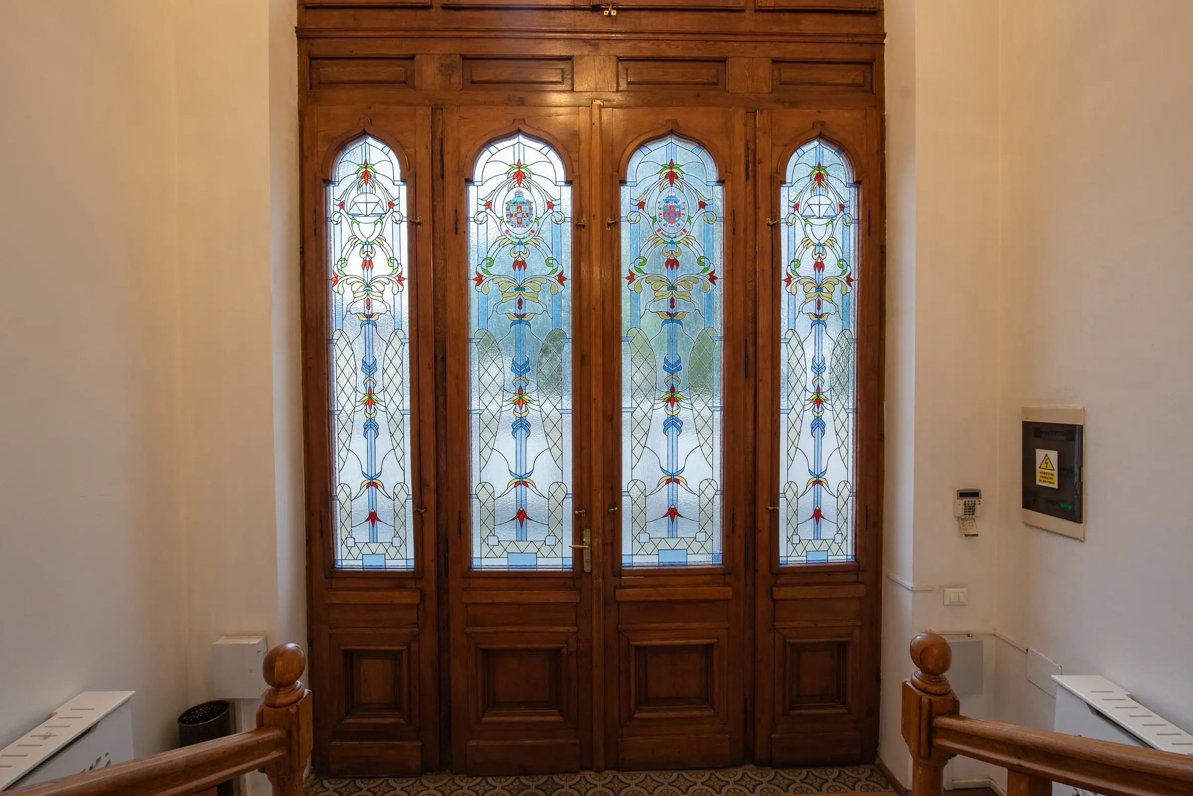 Carved wooden doors with stained glass