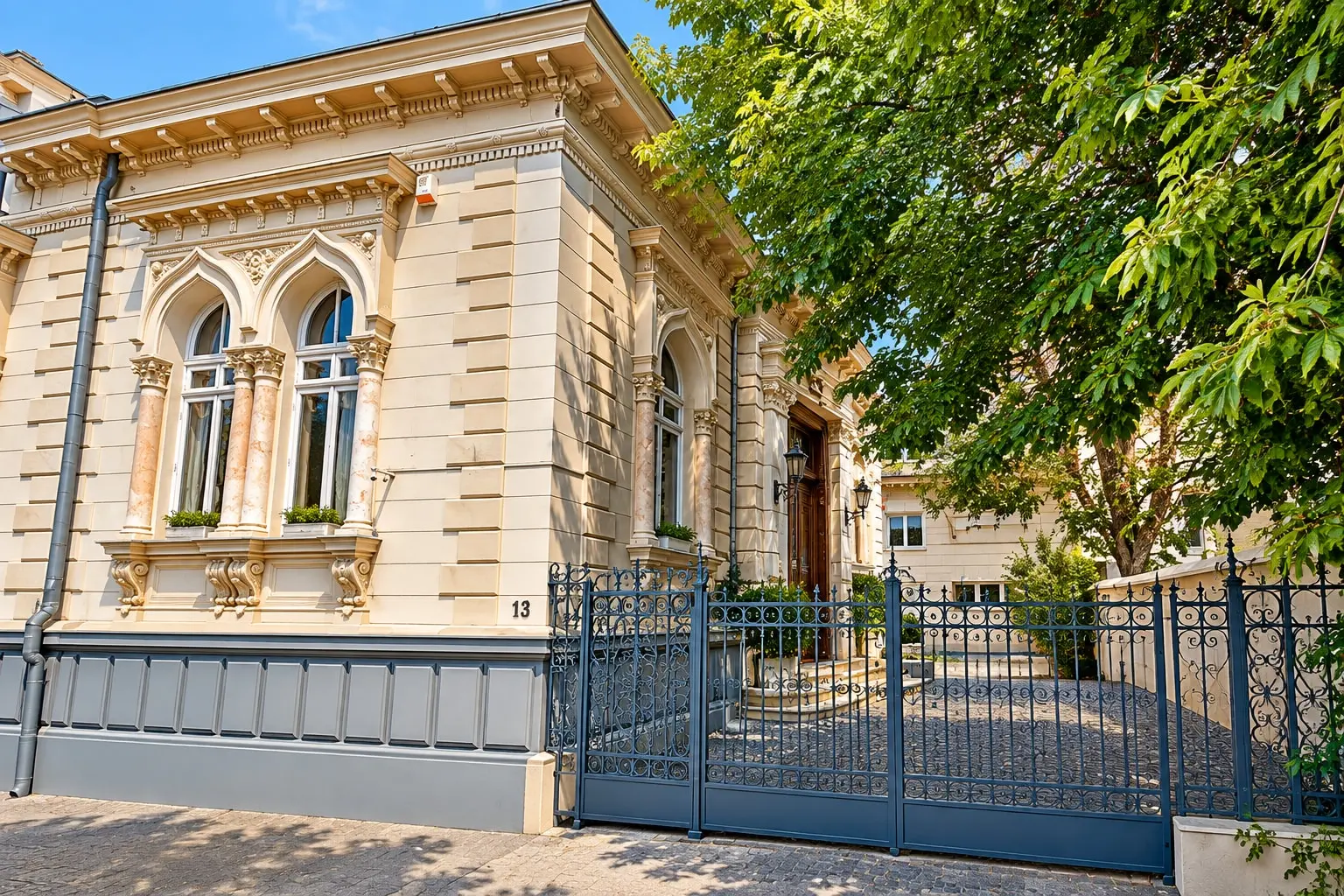 The villa behind its wrought-iron gate