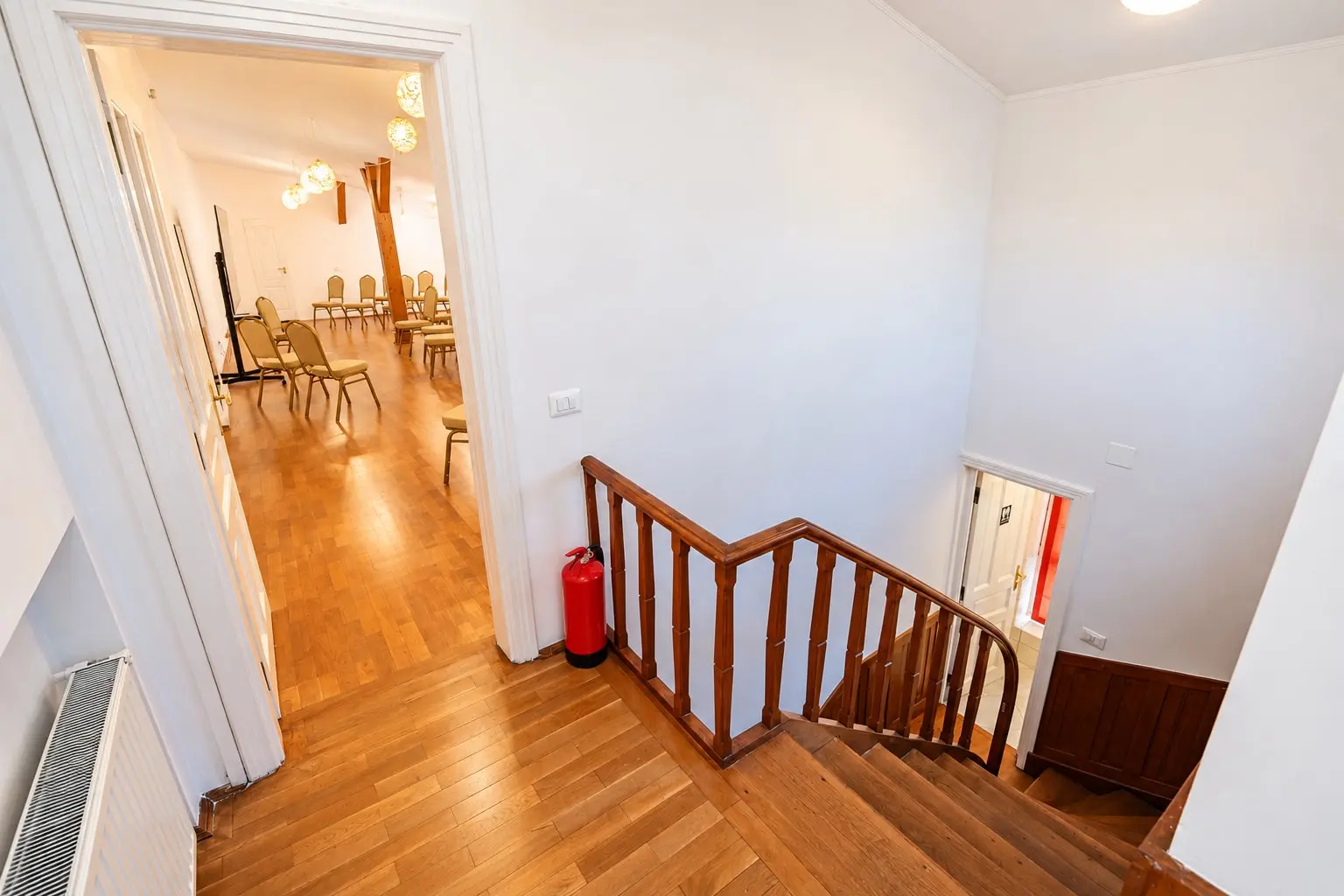 A warm wood hallway leading to a meeting room