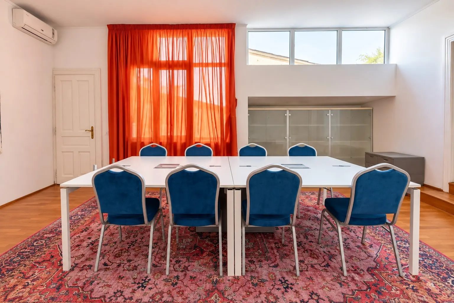 Bright modern conference room with blue chairs