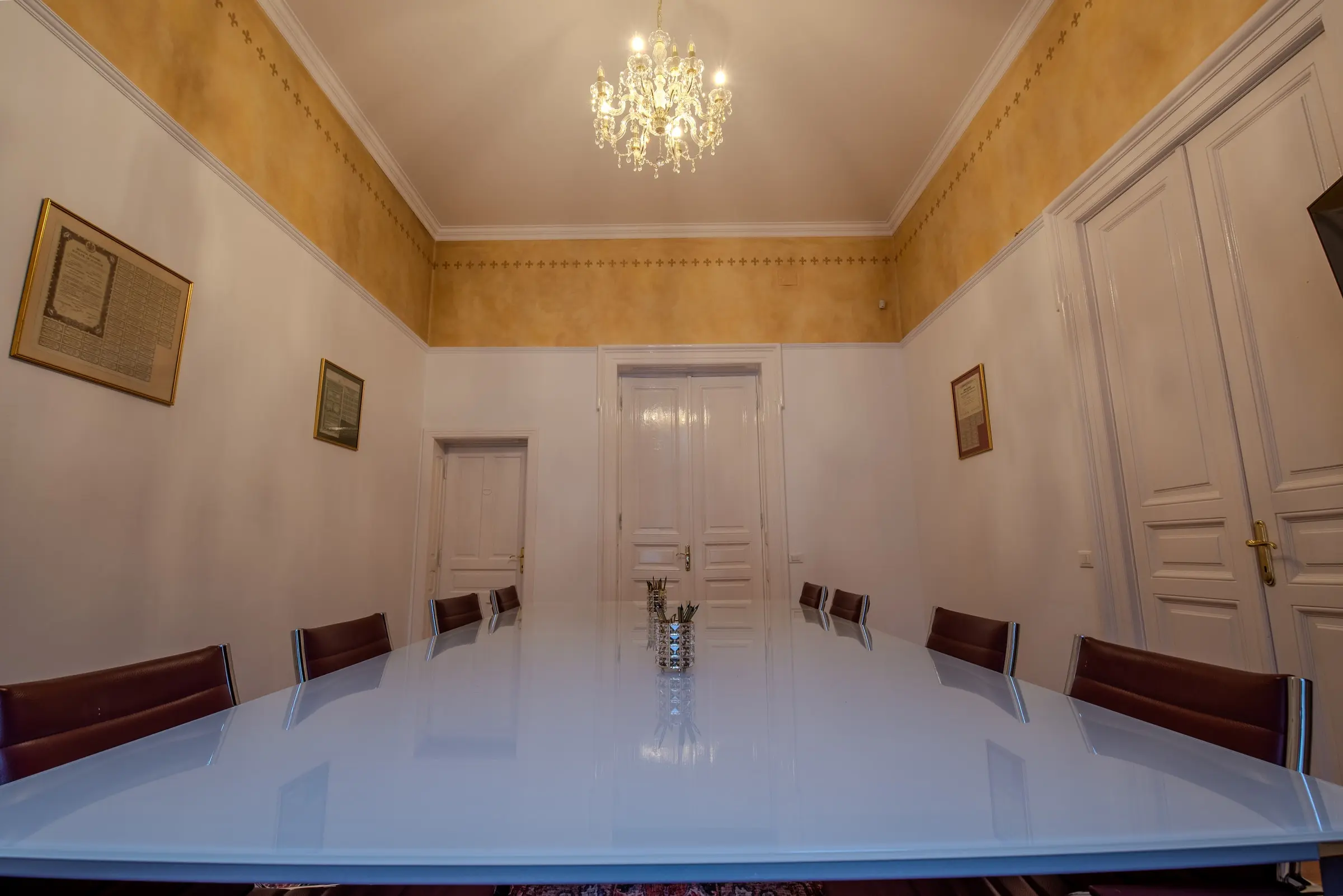 Glass table under a crystal chandelier
