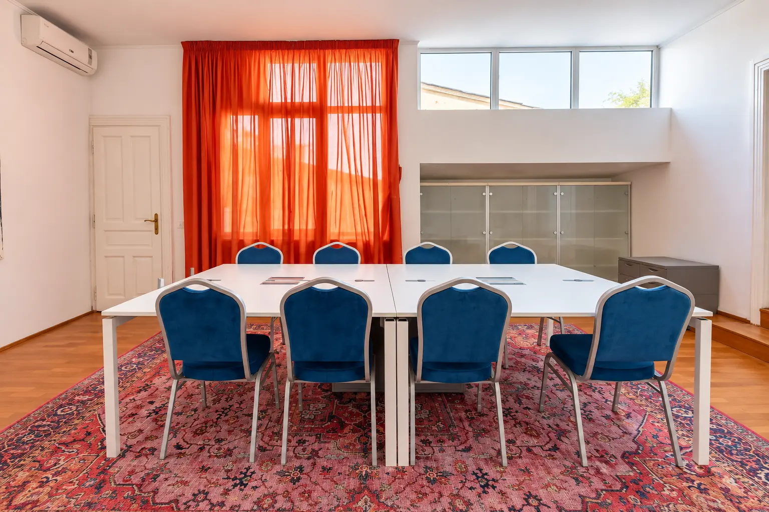 Modern Conference Room with Orange Accents (view 1)