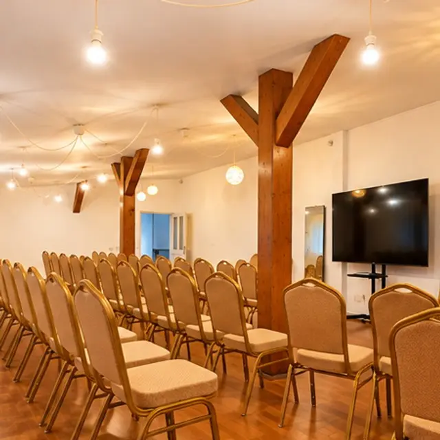 Seminar room with rows of chairs and warm string lights